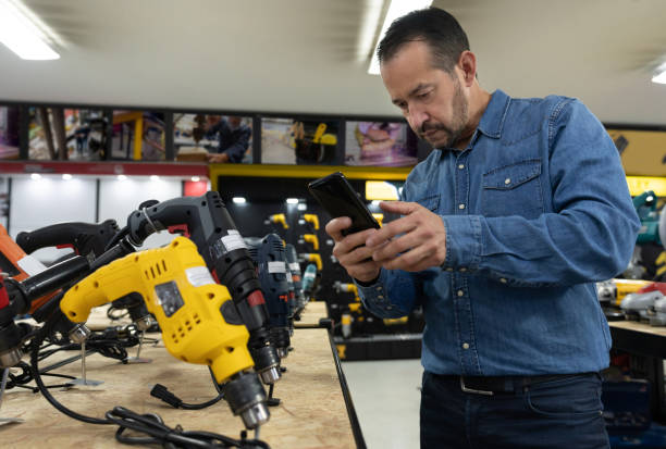 istock Customer shopping at a hardware store and taking a photo of some tools 1323082627