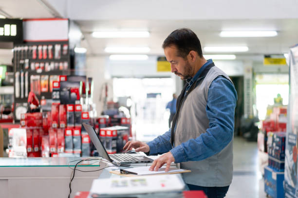 istock Business owner at a hardware store working on his laptop 1323082693