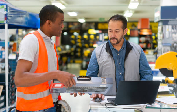istock Salesman helping a customer buying a toolbox at a hardware store 1323082703