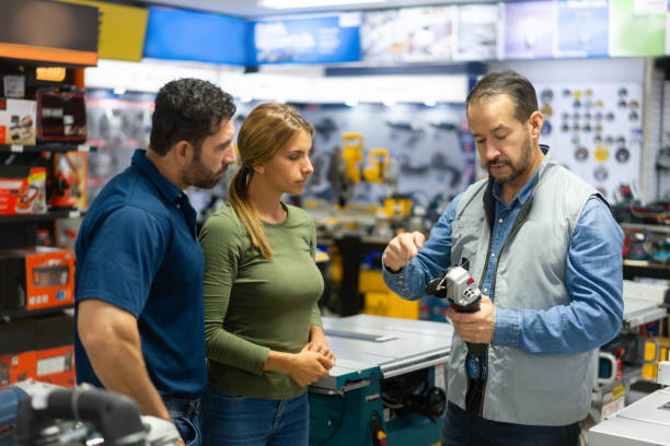 istock Couple buying tools at a hardware store and talking to a salesman 1323082722