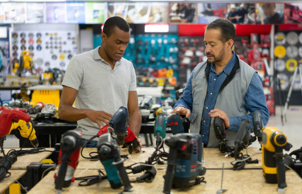 istock Business owner helping a man buying tools at a hardware store 1323082730