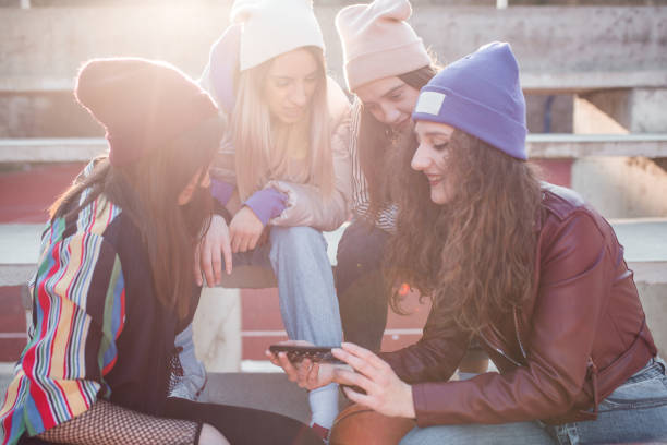 istock Group of young women using mobile phone on bleachers 1323083205