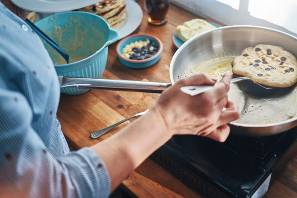 istock Preparing Pancakes with Blueberries in Domestic Kitchen 1323084186