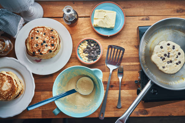 istock Preparing Pancakes with Blueberries in Domestic Kitchen 1323084222