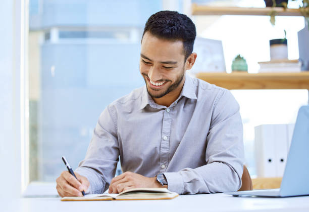 istock Shot of a businessman making notes while sitting at his desk 1323085143