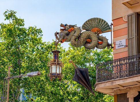 Barcelona, Spain - May 2019: Umbrella House Dragon on La Rambla street in Barcelona