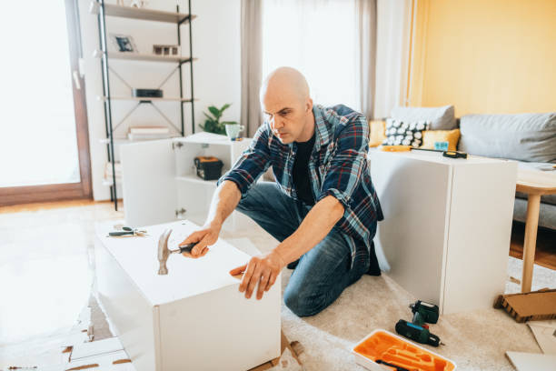 istock Mature man assembling furniture at home 1323087214