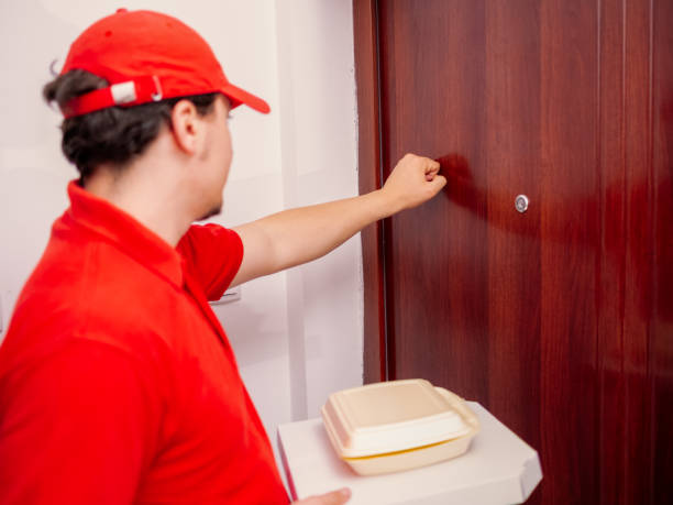 istock delivery man knocking at the door close up 1323087297