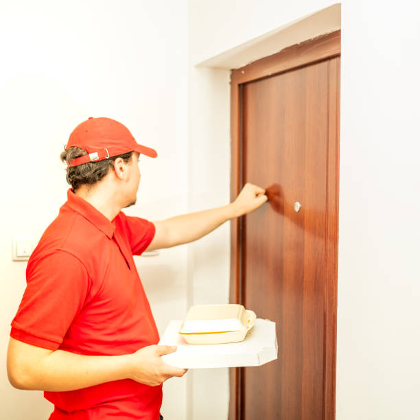 istock Delivery knocking at the door back view close up 1323087337