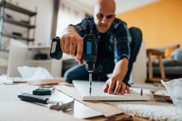 istock Mature man assembling furniture at home 1323087466
