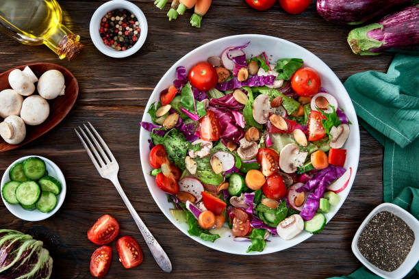 istock Diet concepts. Spring salad shot from above on rustic wood table 1323088061