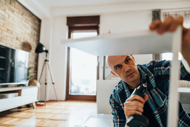 istock Mature man assembling furniture at home 1323088335