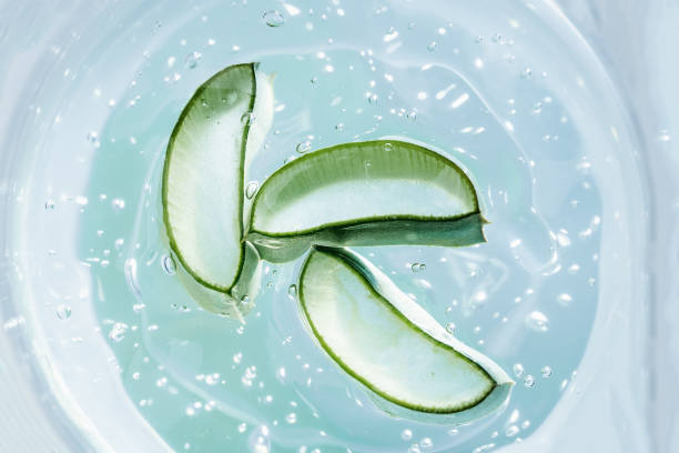 istock Aloe vera slice texture with gel on blue background. 1323089125