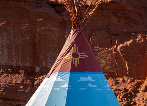 Native American indigenous people decorated Puebloan teepee up close.