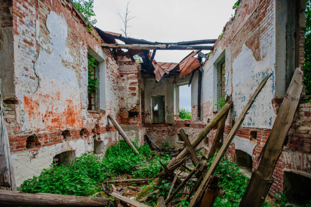 istock Old ancient abandoned red brick ruins overgrown by plants 1323092147