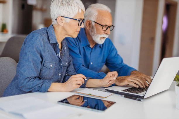 istock Senior couple at home office 1323096510