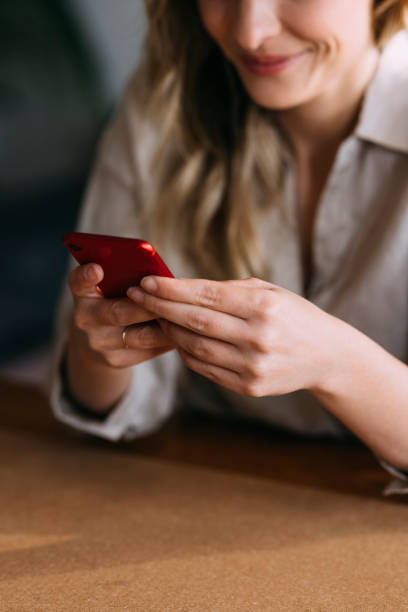 istock Unrecognizable Smiling Woman Using Mobile Phone 1323098164