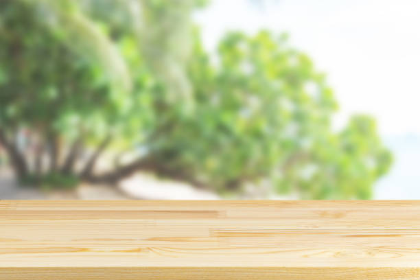 istock wood table top on blurred green wood background 1323098776