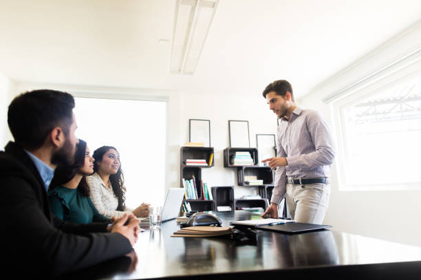 istock Young businessman giving presentation in conference room 1323102438