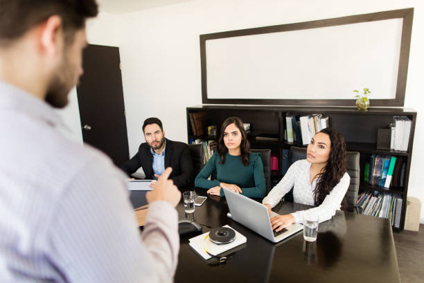 istock Young professionals sitting in conference room with manager 1323102451