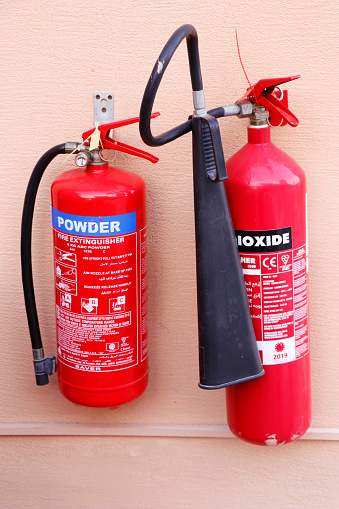 Dubai, United Arab Emirates - May 8, 2021 fire extinguisher hanged on a wall for fire and safety purpose