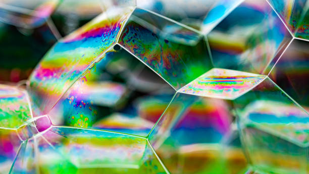 istock Vivid rainbow colours of a Macro soap bubbles creating psychedelic patterns under light dome 1323103861