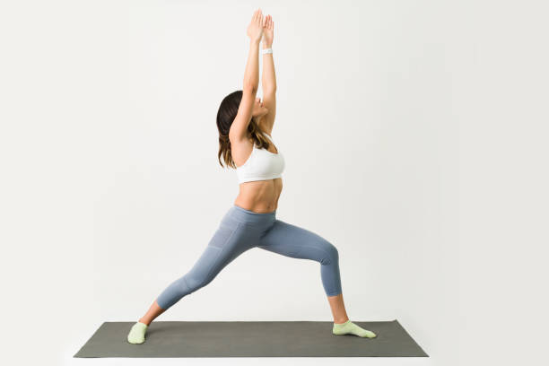 istock Sporty woman practicing yoga at home 1323104811