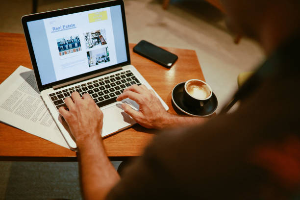 istock young man checking real estate ads on the computer 1323107523