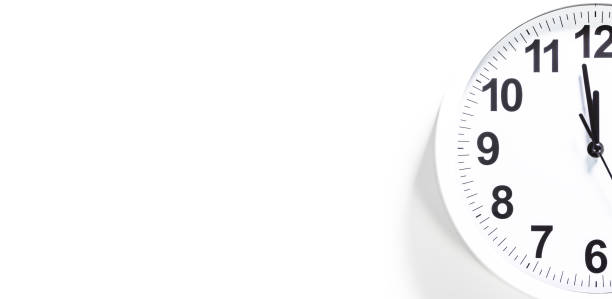 istock Close up to a wall clock, with five minutes to twelve o'clock 1323111625