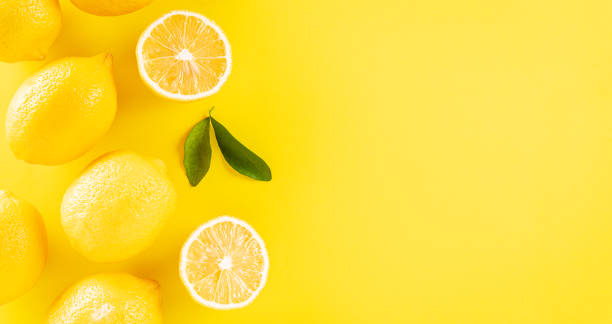 istock Summer composition made from oranges, lemon and green leaves on pastel yellow background. Fruit minimal concept. Flat lay, top view, copy space. 1323113521