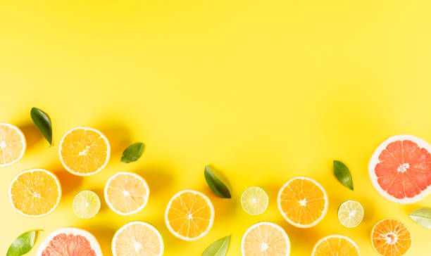 istock Summer composition made from oranges, lemon or lime on pastel yellow background. Fruit minimal concept. Flat lay, top view 1323113944
