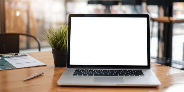 istock Digital tablet with white blank screen on table. workspace in modern office concept. 1323118257