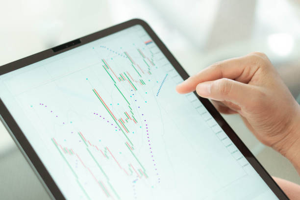 istock Business woman hand holding digital tablet computer with graph of Binary option for trading platform, setective focus 1323122829
