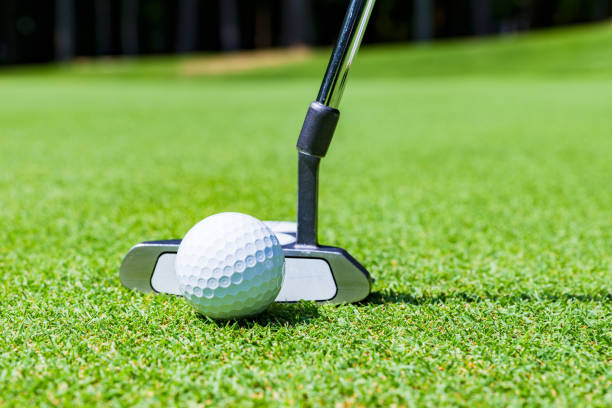 istock putter and golf ball on the green 1323126677