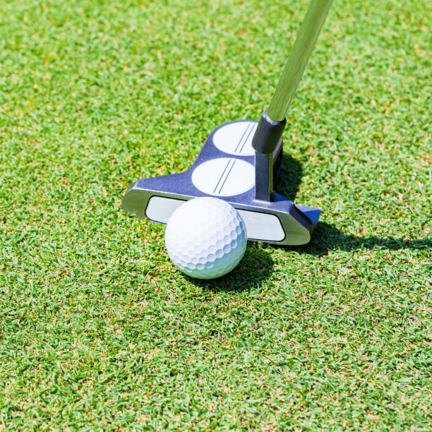 istock putter and golf ball on the green 1323126689