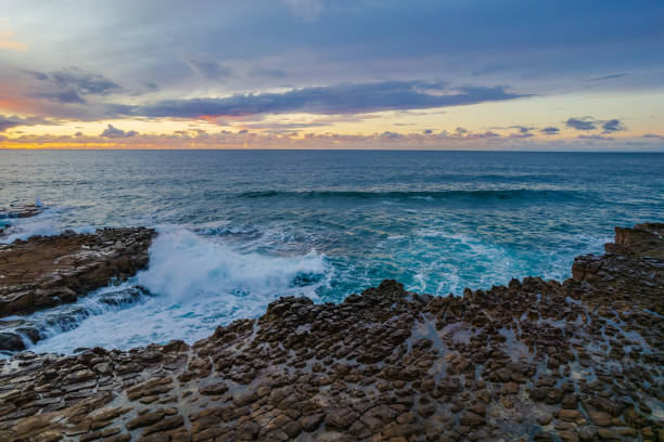 istock Aerial sunrise seascape with clouds and rock platform 1323127503