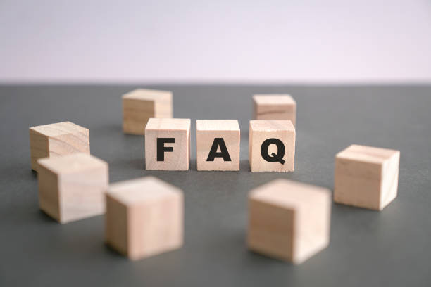 istock FAQ written on wooden blocks on dark grey background. 1323129886