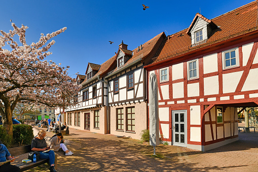 Hofheim, Germany - March 2021: Old historic square with tower and city wall of Hofheim called 'Platz am Untertor' on sunny day
