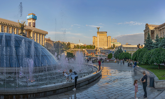 View of the Independence Square with people resting near the fountains and the Independence Monument of Ukraine, Kiev