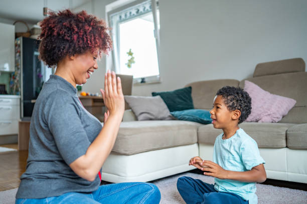 istock Mother playing with her son on the floor 1323136090