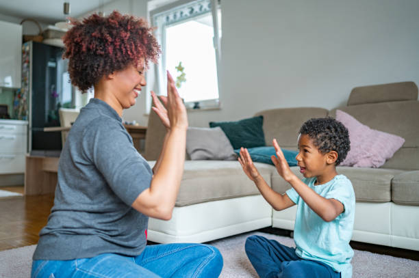 istock Mother playing with her son on the floor 1323136099