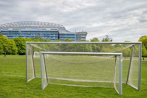 Soccer goals in a park called Fælledparken, which is a very large and popular park in the center of Copenhagen. The soccer goals are placed at the side of the soccer fields and the players can choose the size which fits them