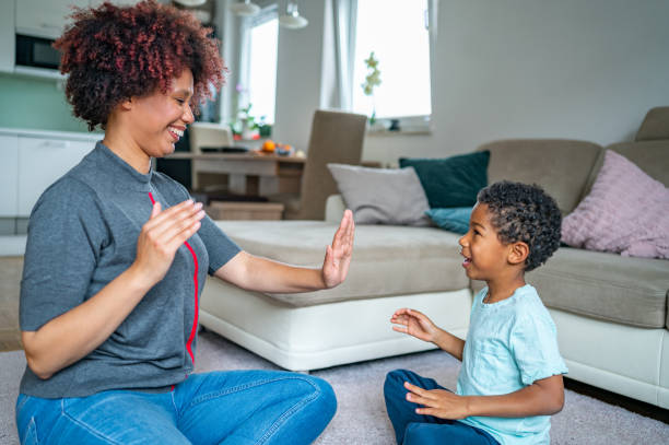 istock Mother playing with her son on the floor 1323136225