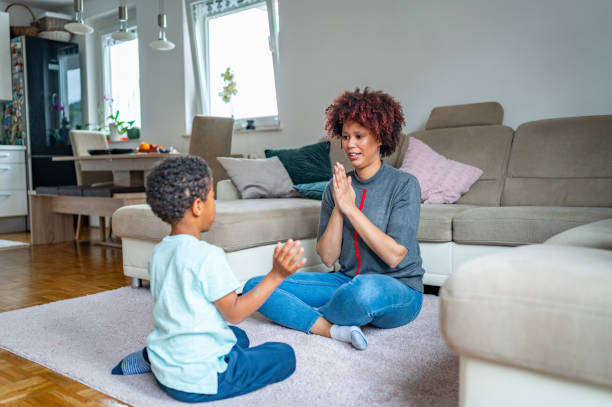 istock Mother playing with her son on the floor 1323136228