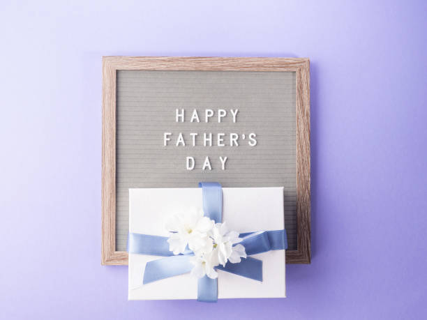 istock Happy fathers day greeting card with letter board and present 1323137530