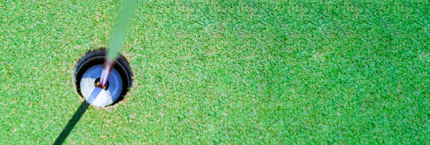 istock golf ball in the cup of green 1323138643