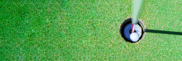 istock golf ball in the cup of green 1323138646