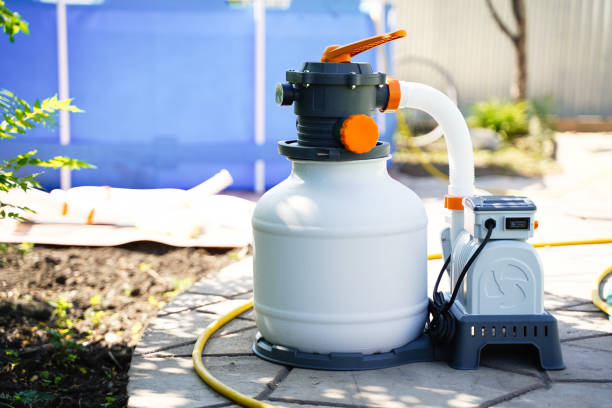 istock Sand filter system for purifying pool water on the background of a frame polyethylene pool 1323138665