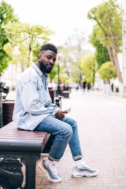 istock Young handsome black businessman using phone outdoors. 1323140636