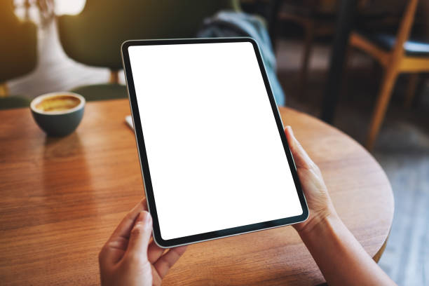 istock a woman holding digital tablet with blank white desktop screen 1323142589